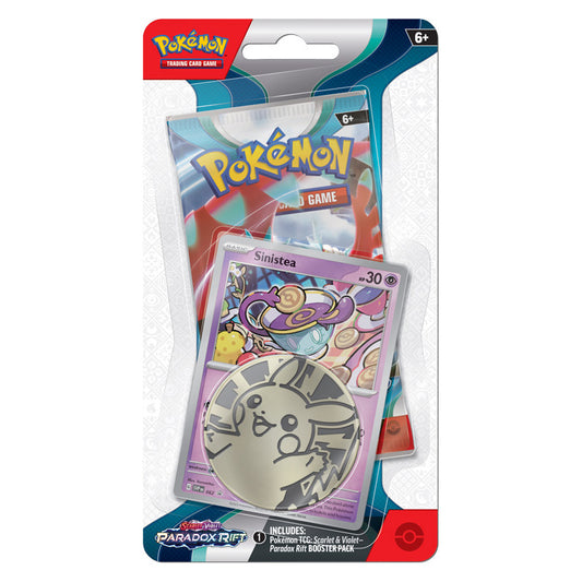 photo of sinistea with pikachu coin and booster pack of paradox rift sealed in blister packaging